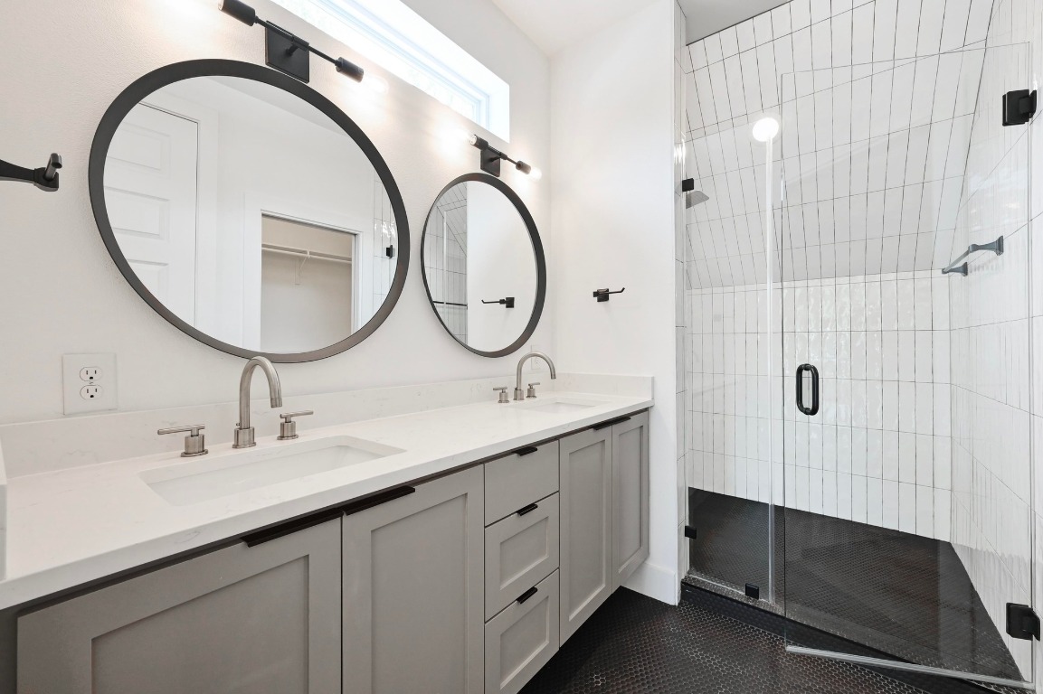 504 Normandy Street, Unit A Austin, TX 78745 - Photo 10 of 20 a bathroom with a double vanity sink and a mirror