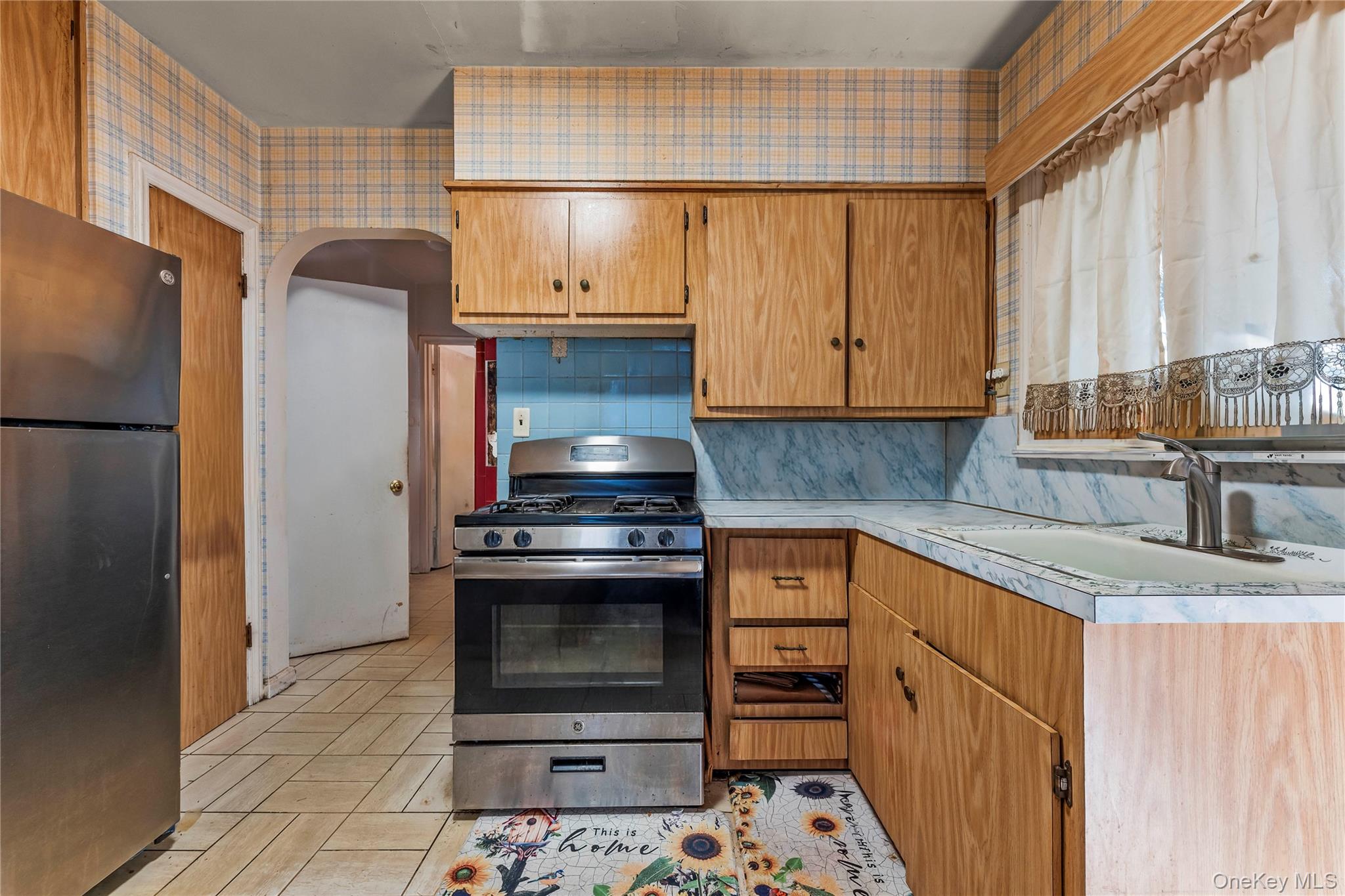 208 Dogwood Road Valley Stream, NY 11580 - Photo 13 of 38 a kitchen with granite countertop a sink stove and refrigerator