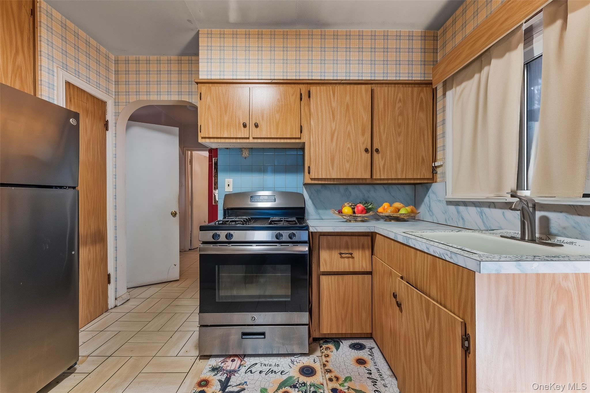 208 Dogwood Road Valley Stream, NY 11580 - Photo 14 of 38 a kitchen with stainless steel appliances granite countertop a stove a refrigerator and a sink