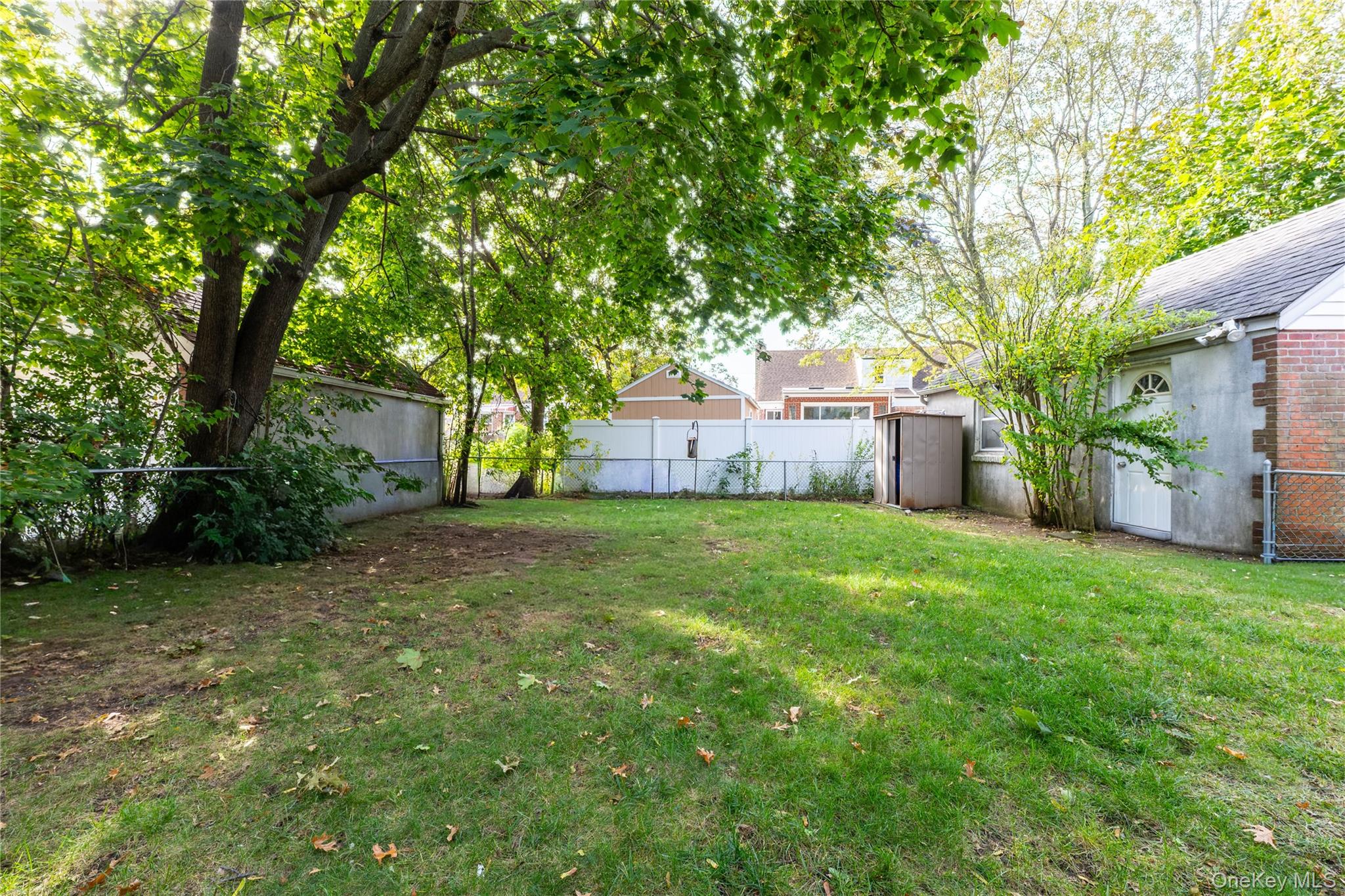208 Dogwood Road Valley Stream, NY 11580 - Photo 32 of 38 a view of a house with backyard and a tree