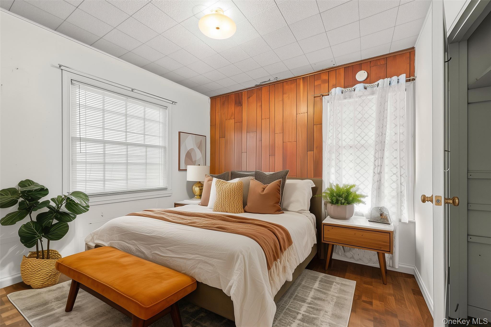208 Dogwood Road Valley Stream, NY 11580 - Photo 7 of 38 a bedroom with a bed table flowerpot and window