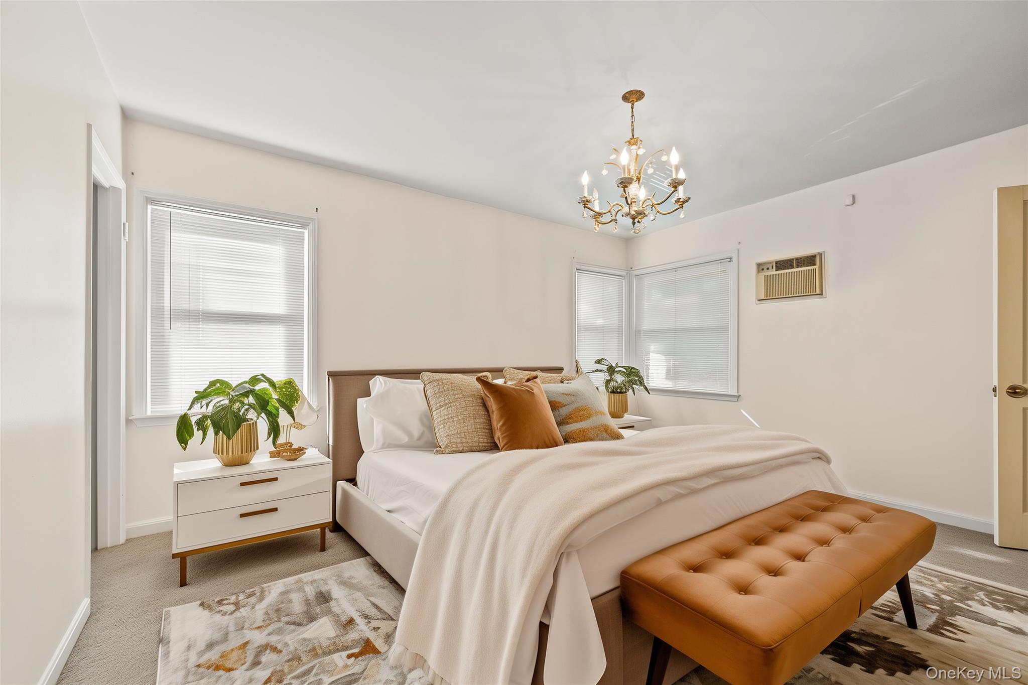 208 Dogwood Road Valley Stream, NY 11580 - Photo 9 of 38 a bedroom with a bed and a chandelier