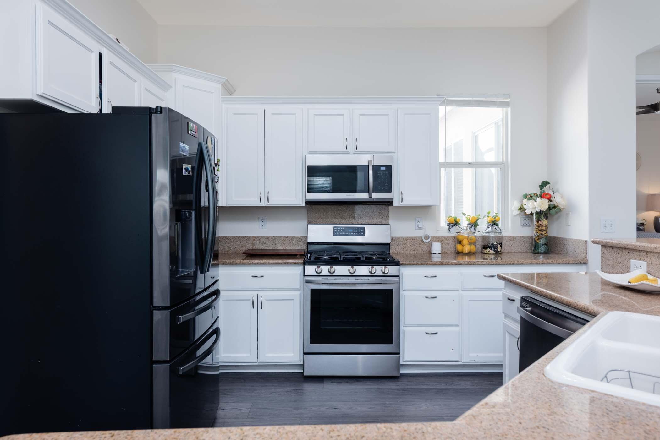 49534 Lewis Road Indio, CA 92201 - Photo 14 of 44 a kitchen with a stove a refrigerator and a sink