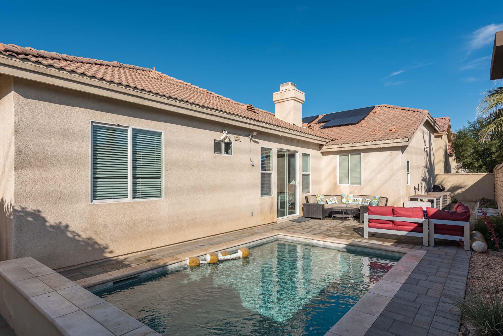 49534 Lewis Road Indio, CA 92201 - Photo 35 of 44 a swimming pool with outdoor seating