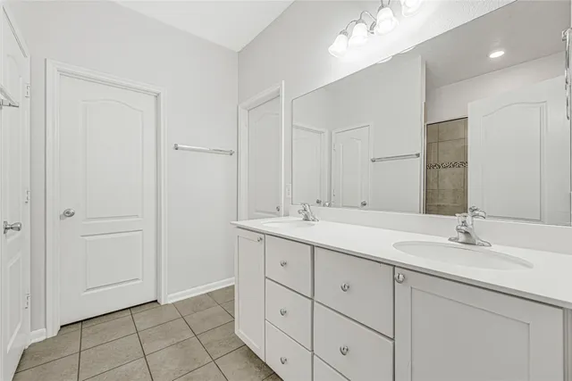 a bathroom with a double vanity sink mirror and