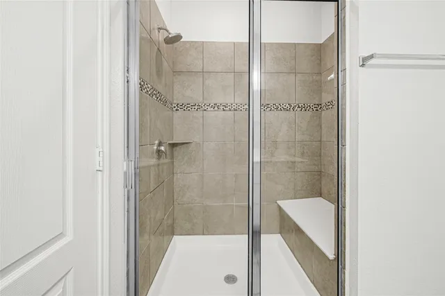 a bathroom with a shower and a sink
