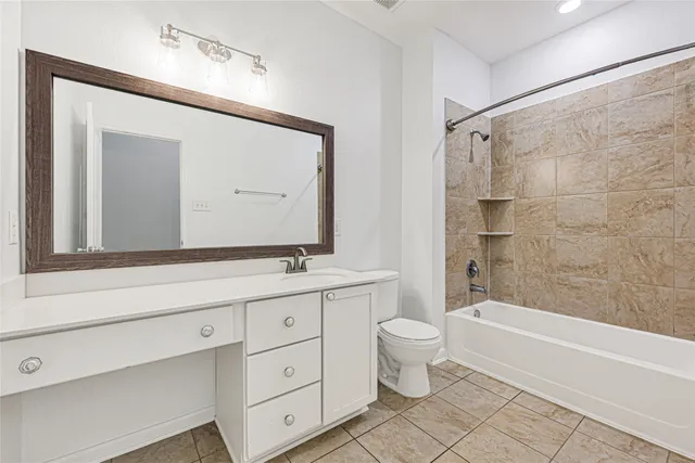 a bathroom with a double vanity sink toilet mirror and bathtub