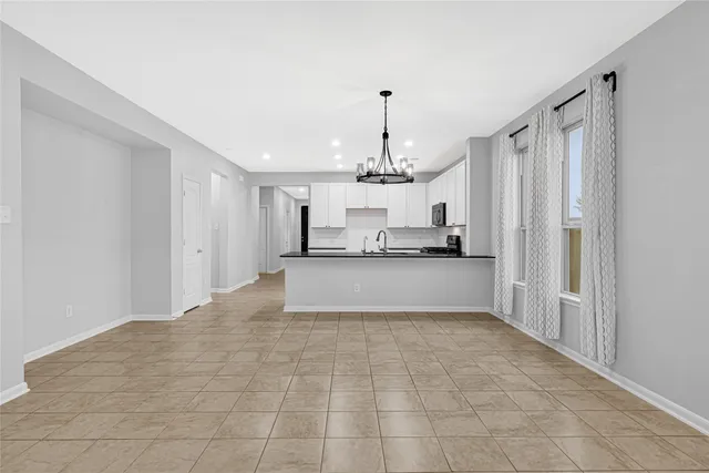 a view of a kitchen with refrigerator and cabinets