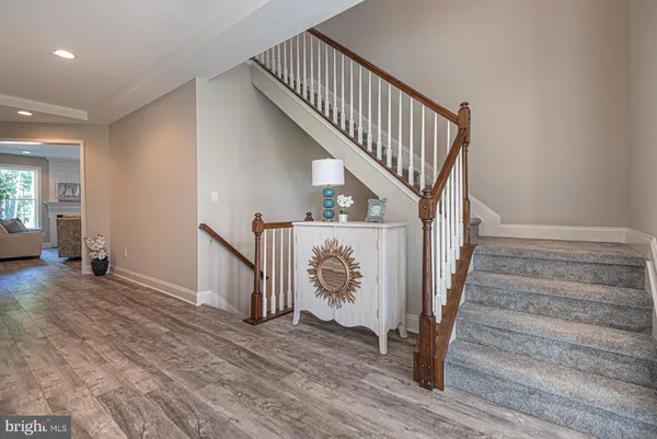 a view of entryway with wooden floor and stairs