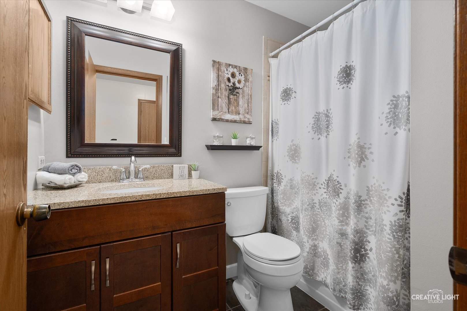S085 Pleasant Hill Road Wheaton, IL 60187 - Photo 21 of 27 a bathroom with a granite countertop sink toilet a mirror and shower