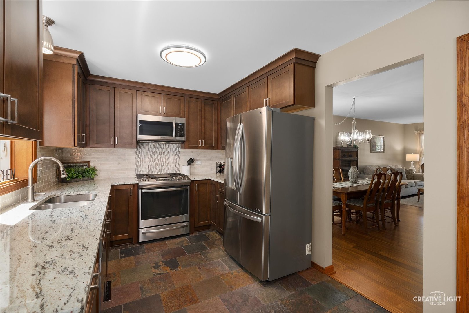 S085 Pleasant Hill Road Wheaton, IL 60187 - Photo 8 of 27 a kitchen with granite countertop a refrigerator stove and sink