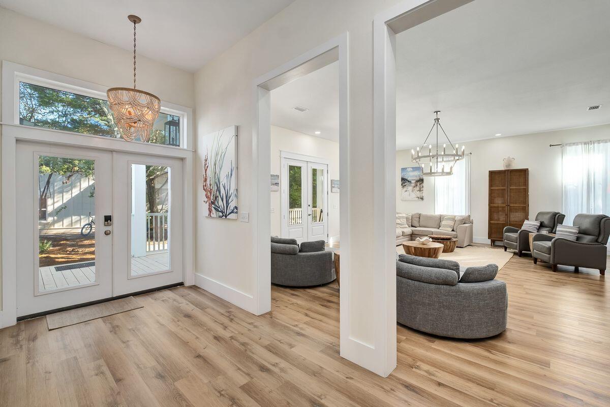 251 Dogwood Street Santa Rosa Beach, FL 32459 - Photo 11 of 51 a living room with furniture and a chandelier