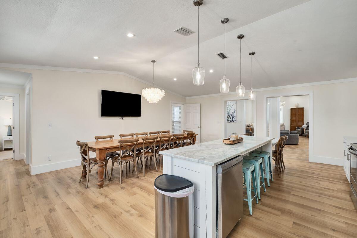 251 Dogwood Street Santa Rosa Beach, FL 32459 - Photo 14 of 51 a kitchen with stainless steel appliances granite countertop a sink a stove and a wooden floor
