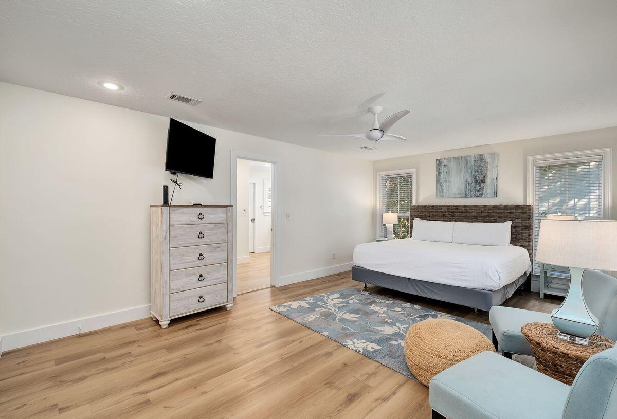 251 Dogwood Street Santa Rosa Beach, FL 32459 - Photo 18 of 51 a spacious bedroom with a bed and a flat screen tv
