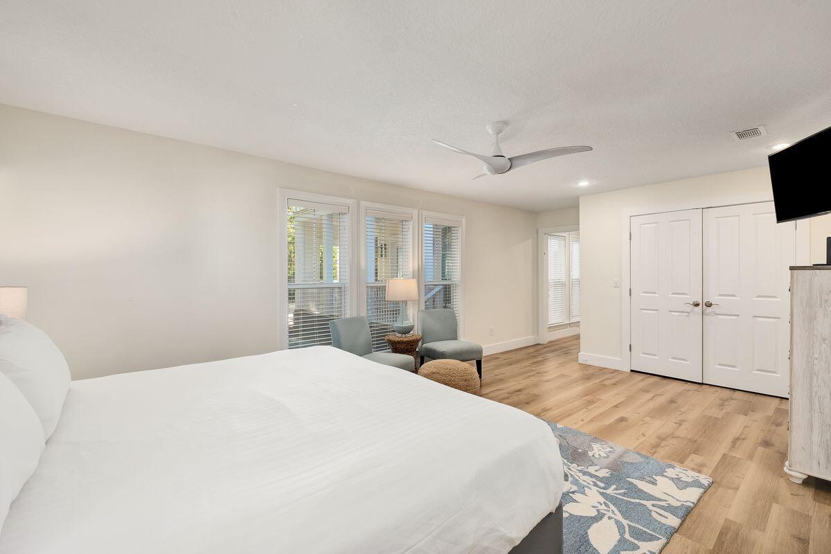 251 Dogwood Street Santa Rosa Beach, FL 32459 - Photo 21 of 51 a spacious bedroom with a bed and a flat screen tv