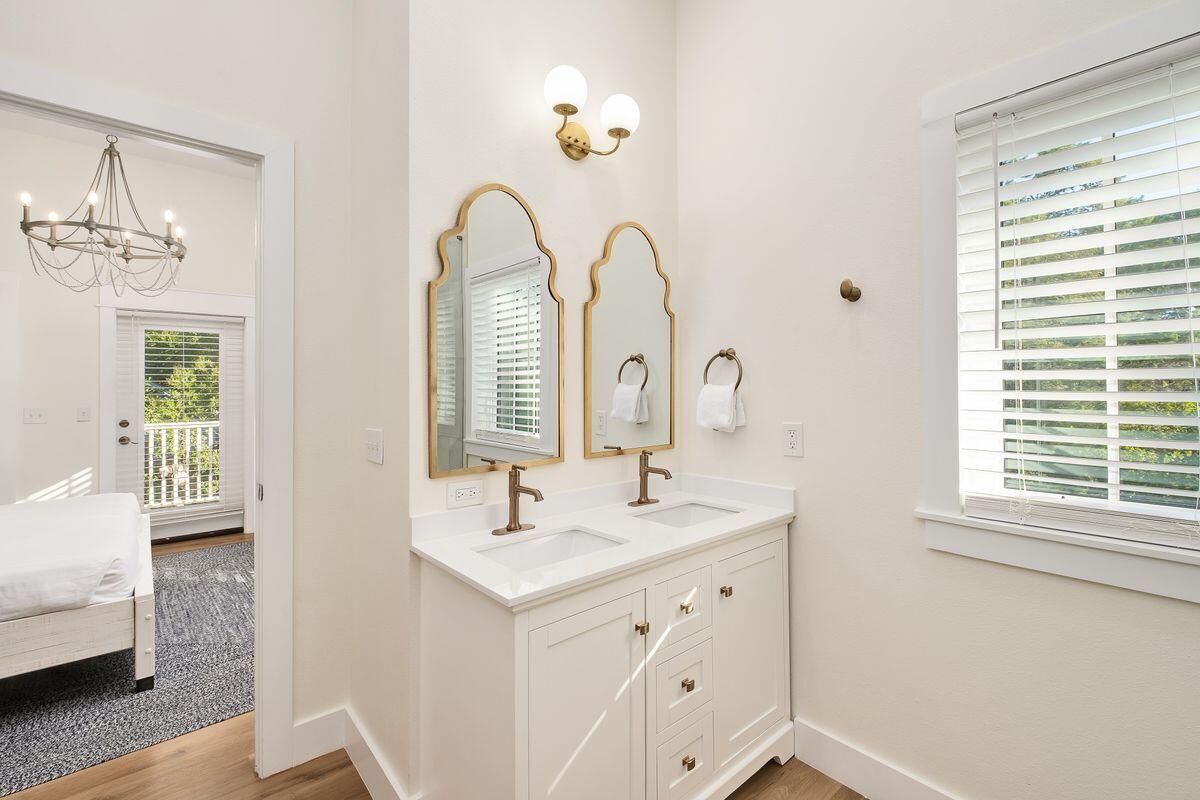 251 Dogwood Street Santa Rosa Beach, FL 32459 - Photo 32 of 51 a bathroom with a double vanity sink a mirror and a window