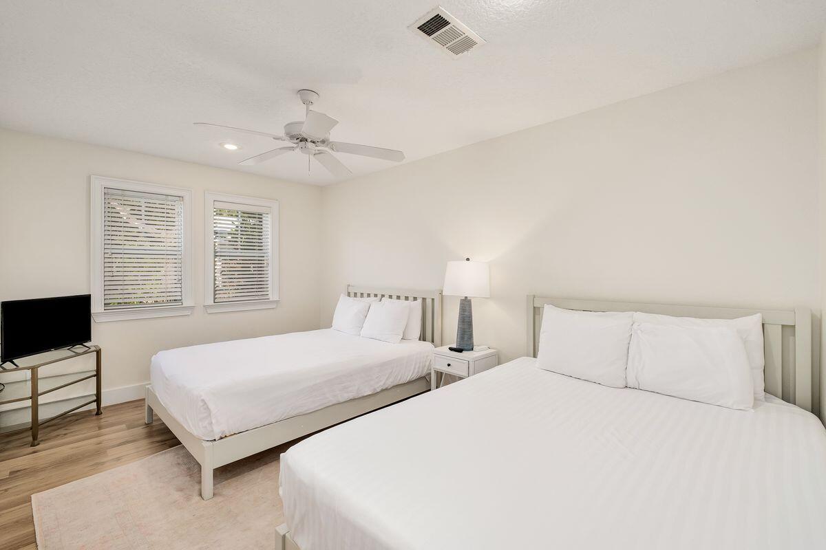 251 Dogwood Street Santa Rosa Beach, FL 32459 - Photo 38 of 51 a bedroom with two beds and a night stand
