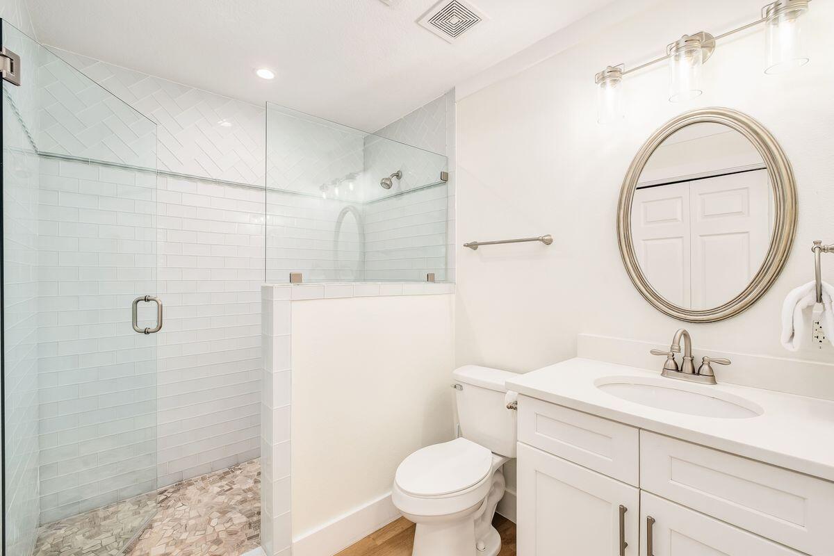251 Dogwood Street Santa Rosa Beach, FL 32459 - Photo 39 of 51 a bathroom with a sink a toilet and a mirror