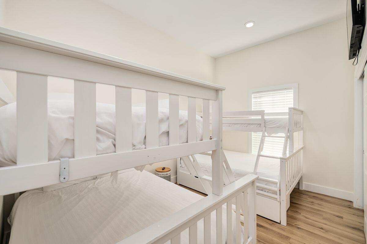 251 Dogwood Street Santa Rosa Beach, FL 32459 - Photo 40 of 51 a view of a bedroom with wooden floor and furniture