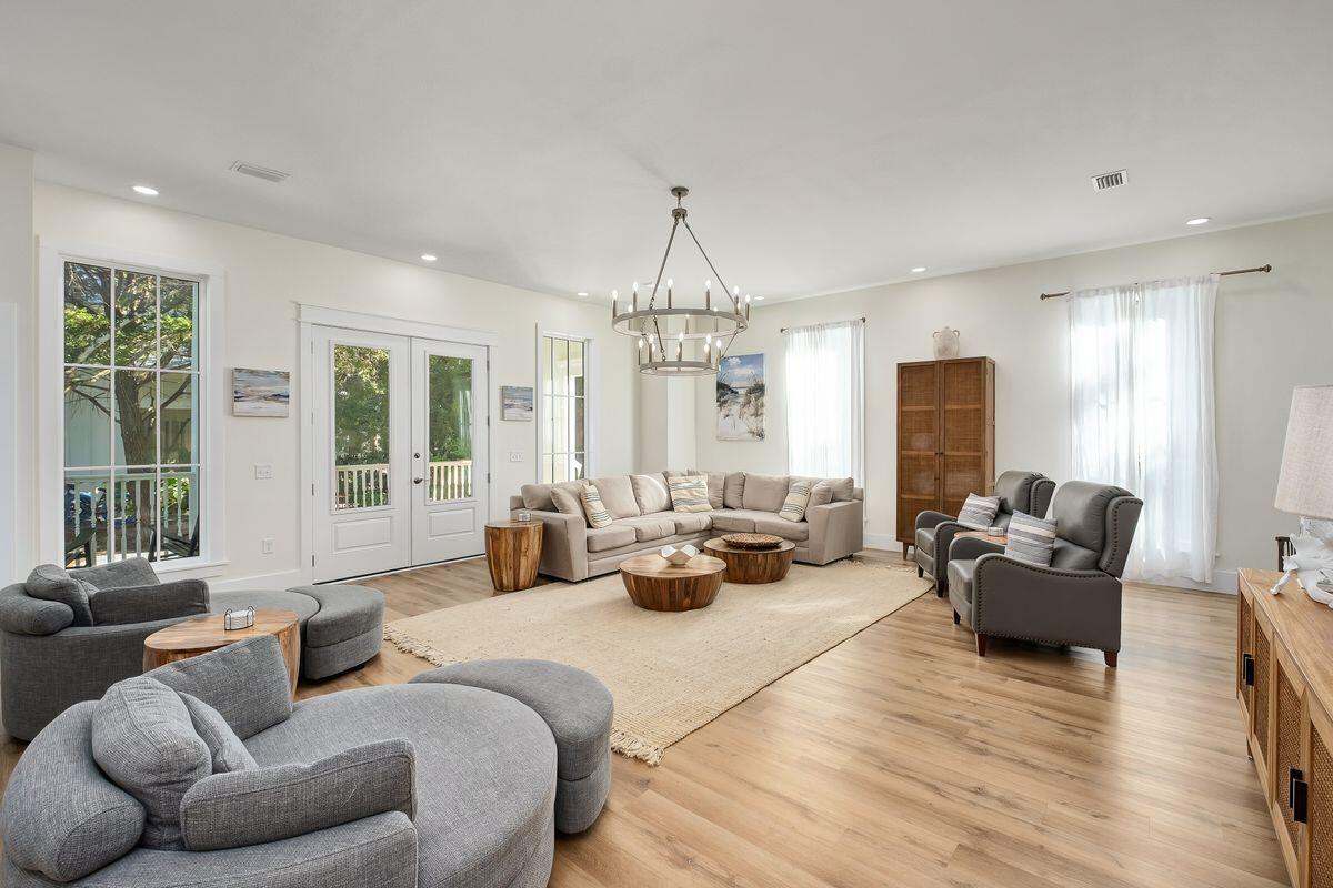 251 Dogwood Street Santa Rosa Beach, FL 32459 - Photo 7 of 51 a living room with furniture or chandelier and a wooden floor