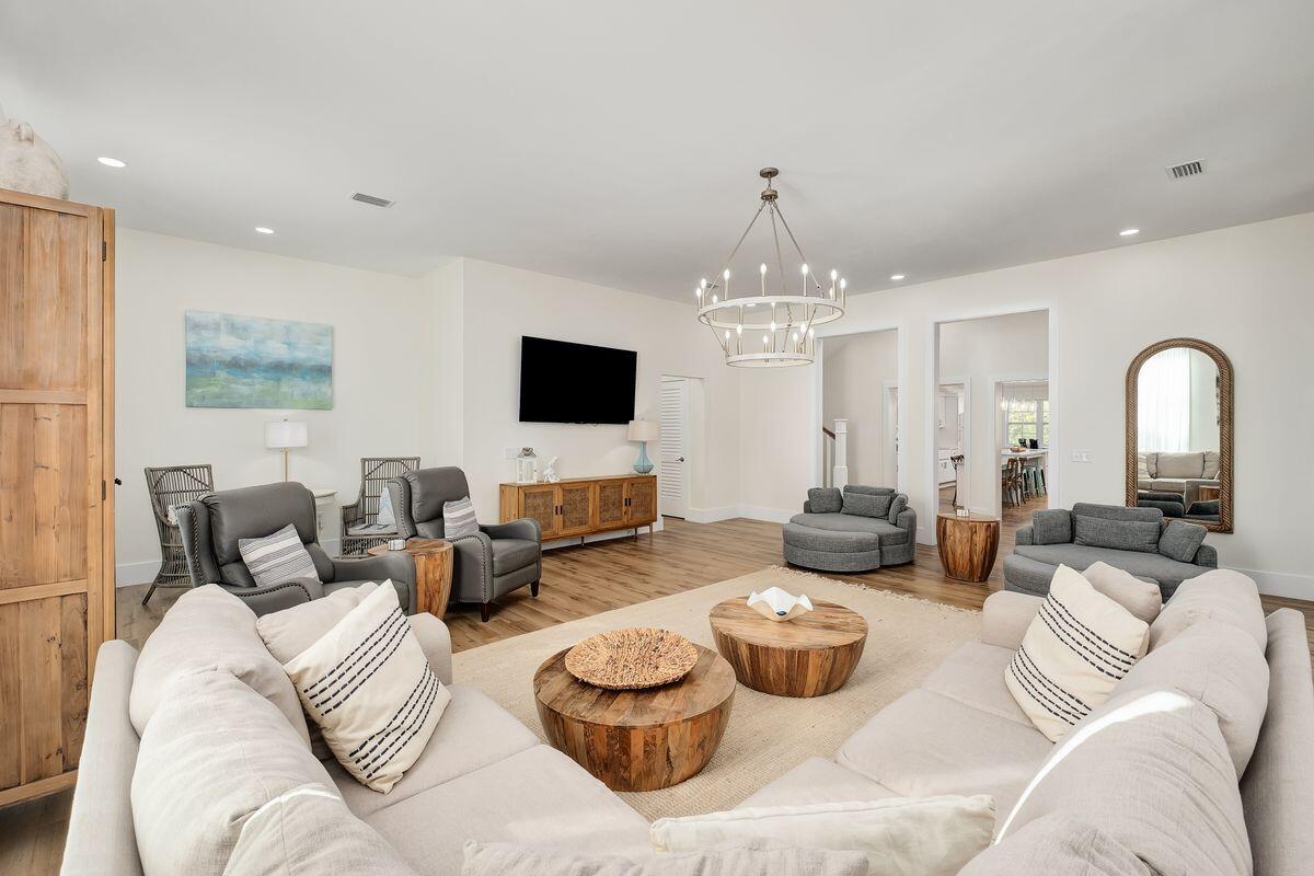 251 Dogwood Street Santa Rosa Beach, FL 32459 - Photo 9 of 51 a living room with furniture and a chandelier