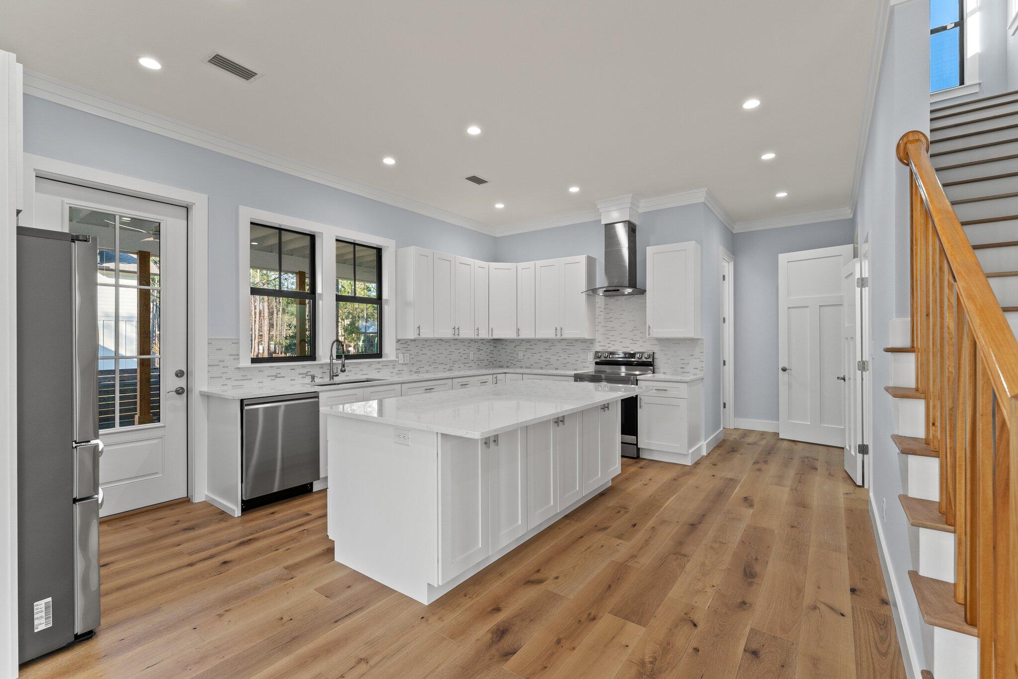 50 Cord Road Santa Rosa Beach, FL 32459 - Photo 18 of 73 a kitchen with stainless steel appliances granite countertop a refrigerator a stove and a wooden floors