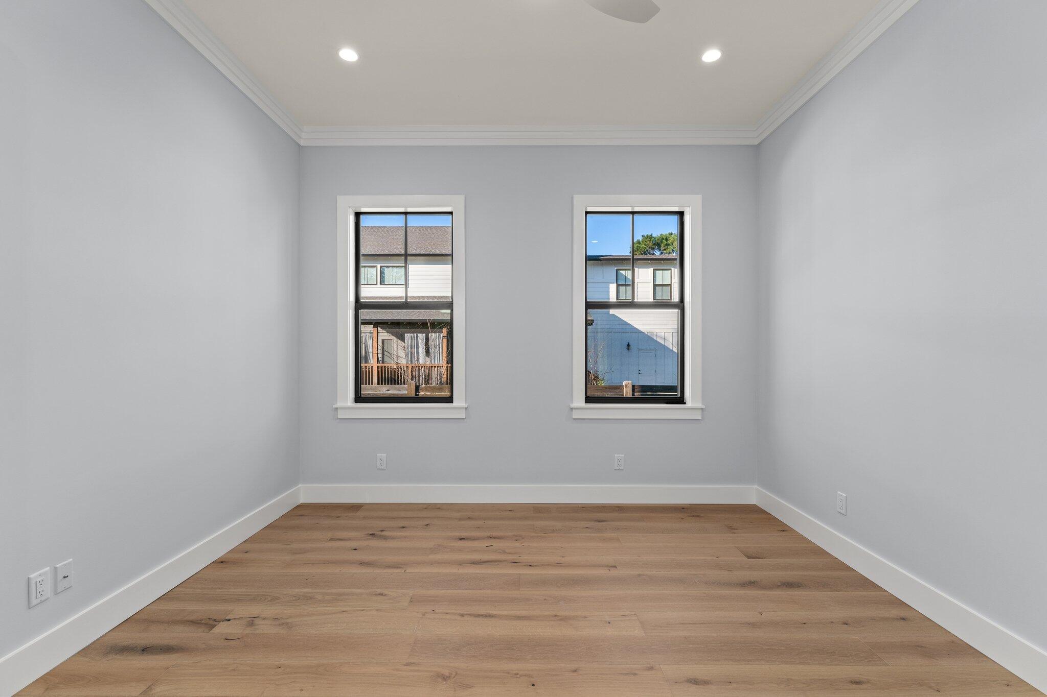 50 Cord Road Santa Rosa Beach, FL 32459 - Photo 23 of 73 an empty room with wooden floor and windows