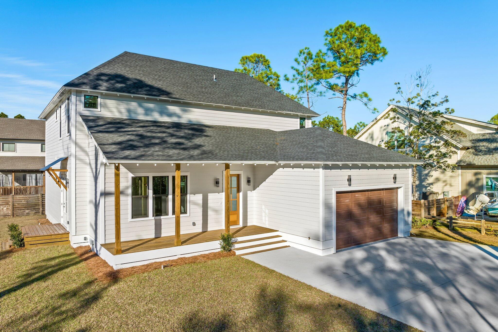 50 Cord Road Santa Rosa Beach, FL 32459 - Photo 3 of 73 a front view of a house with a yard and garage