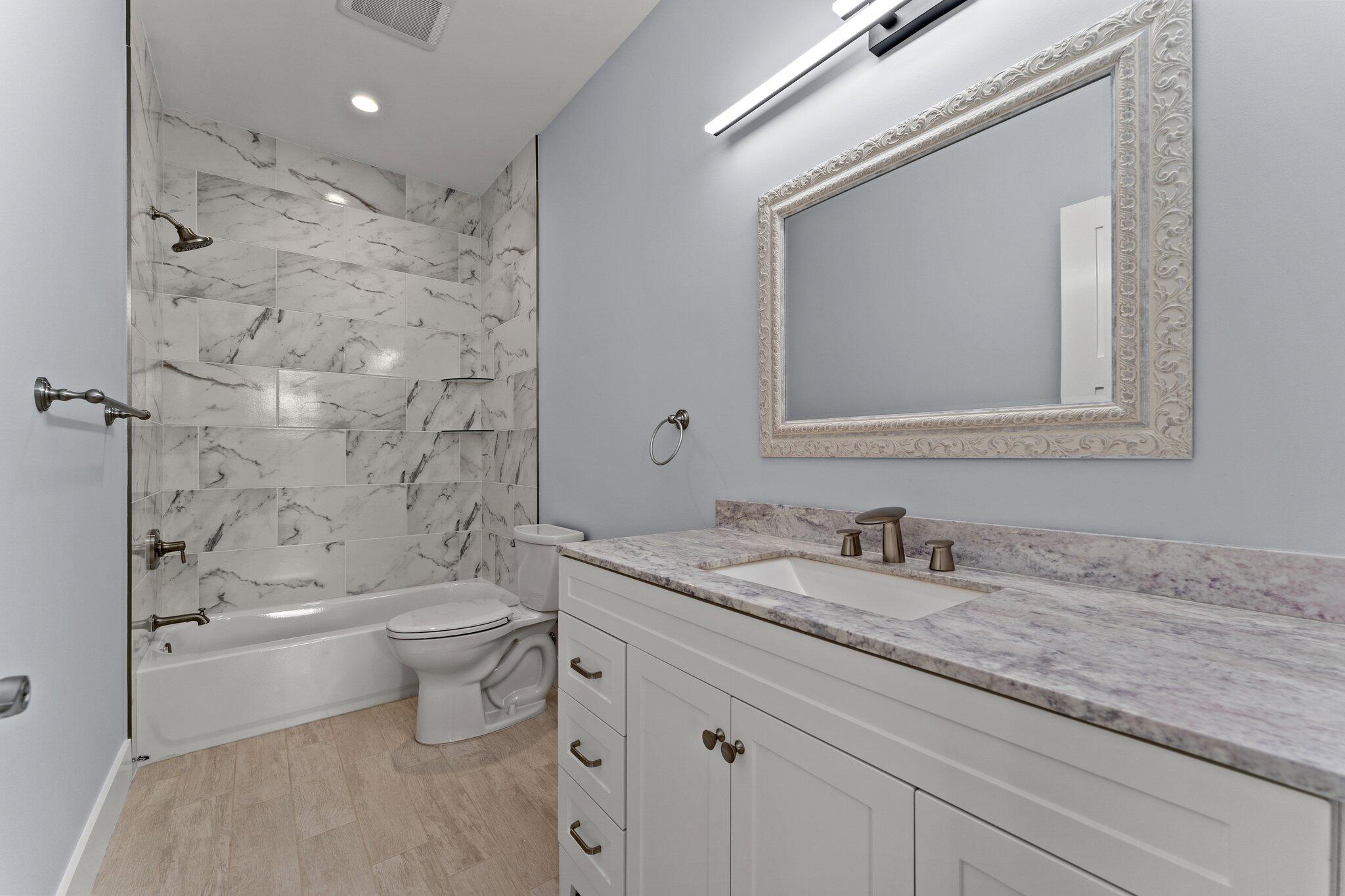 50 Cord Road Santa Rosa Beach, FL 32459 - Photo 50 of 73 a bathroom with a granite countertop sink a toilet and bathtub