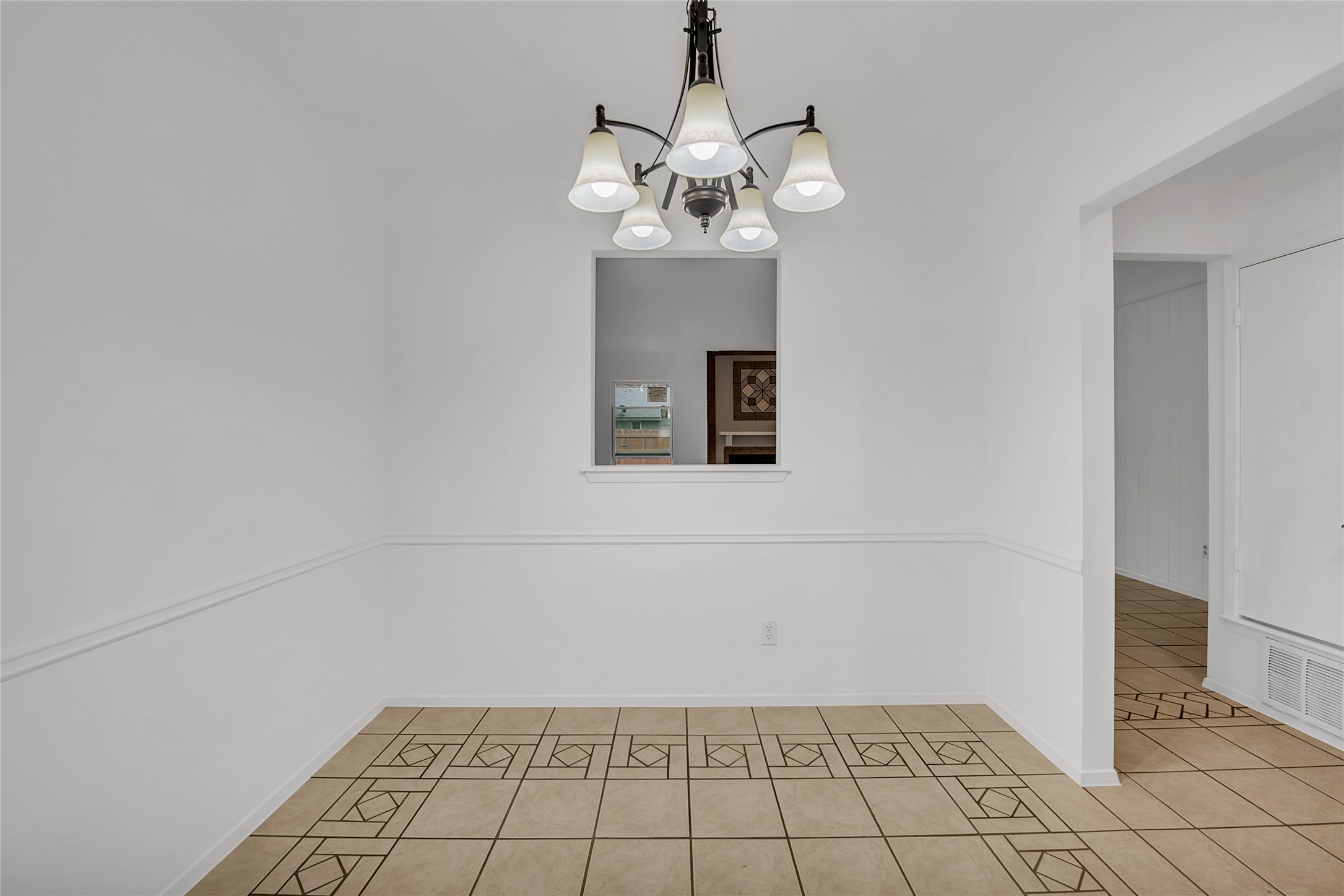 7209 Gunnison Pass Austin, TX 78724 - Photo 7 of 19 A well-lit dining area features a decorative ceiling fixture and practical tile flooring.
