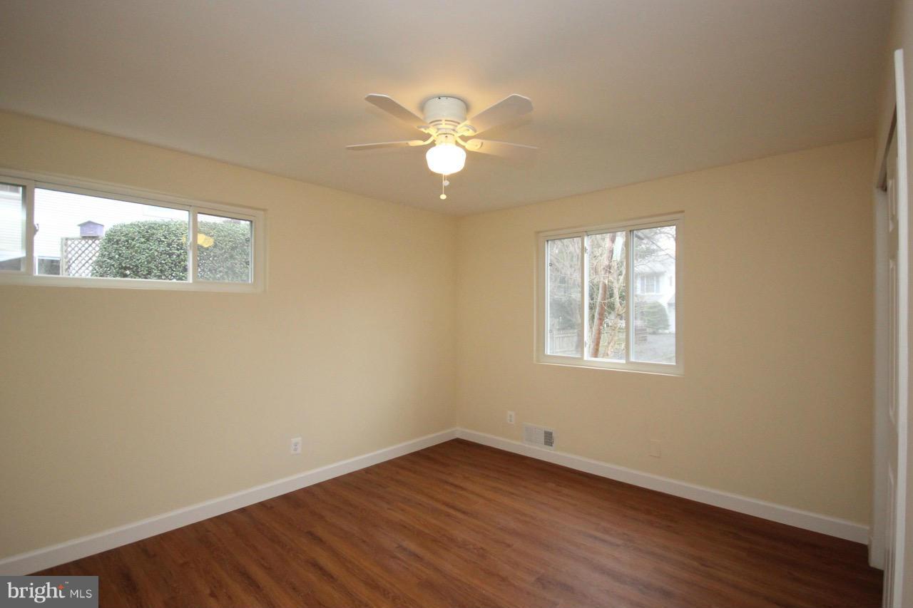 1901 North Quebec Street, Unit MIDDLE Arlington, VA 22207 - Photo 13 of 21 a view of an empty room with wooden floor and a window