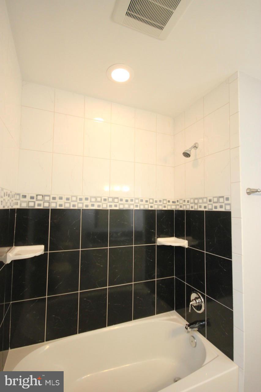 1901 North Quebec Street, Unit MIDDLE Arlington, VA 22207 - Photo 16 of 21 a view of a bathroom with a bathtub