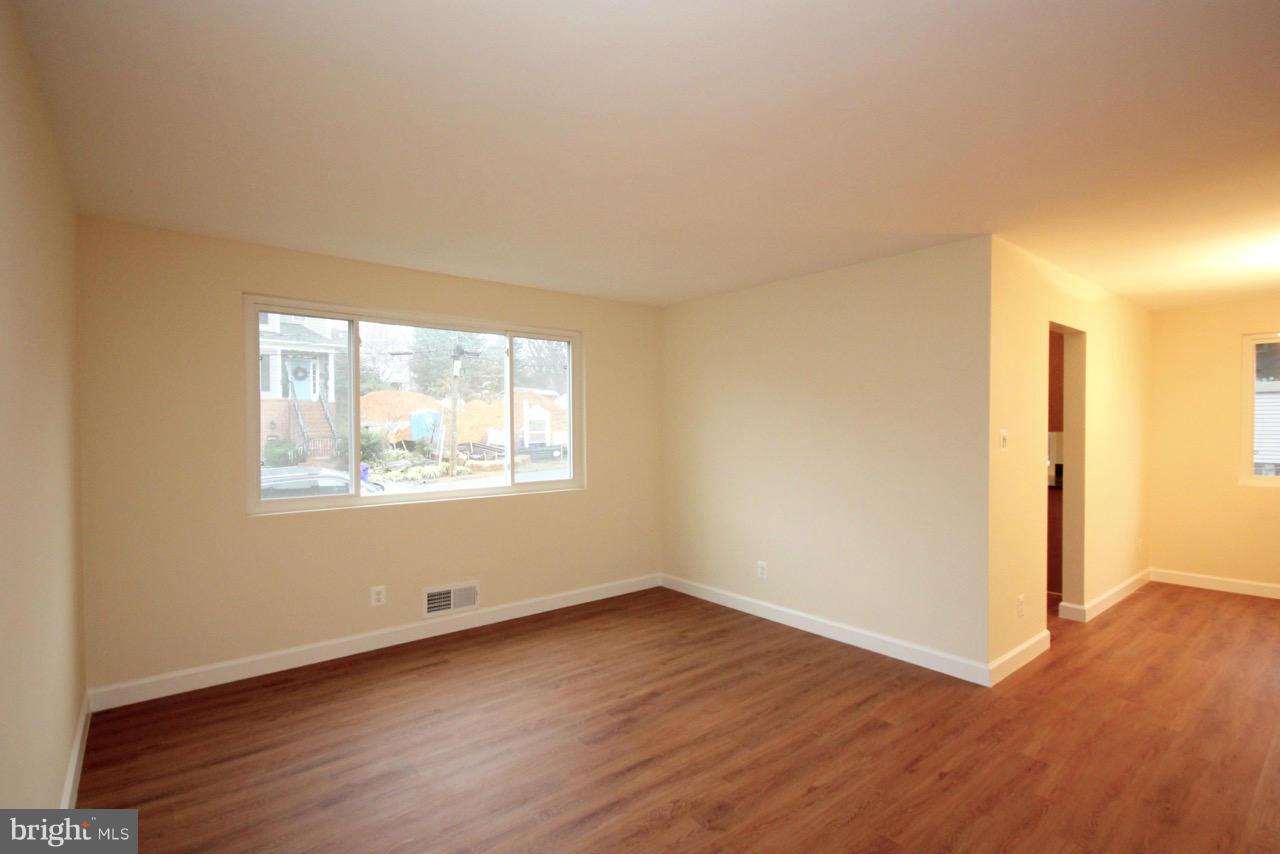 1901 North Quebec Street, Unit MIDDLE Arlington, VA 22207 - Photo 5 of 21 an empty room with wooden floor and windows