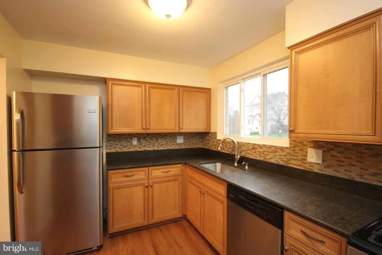 1901 North Quebec Street, Unit MIDDLE Arlington, VA 22207 - Photo 10 of 21 a kitchen with a sink a refrigerator and cabinets