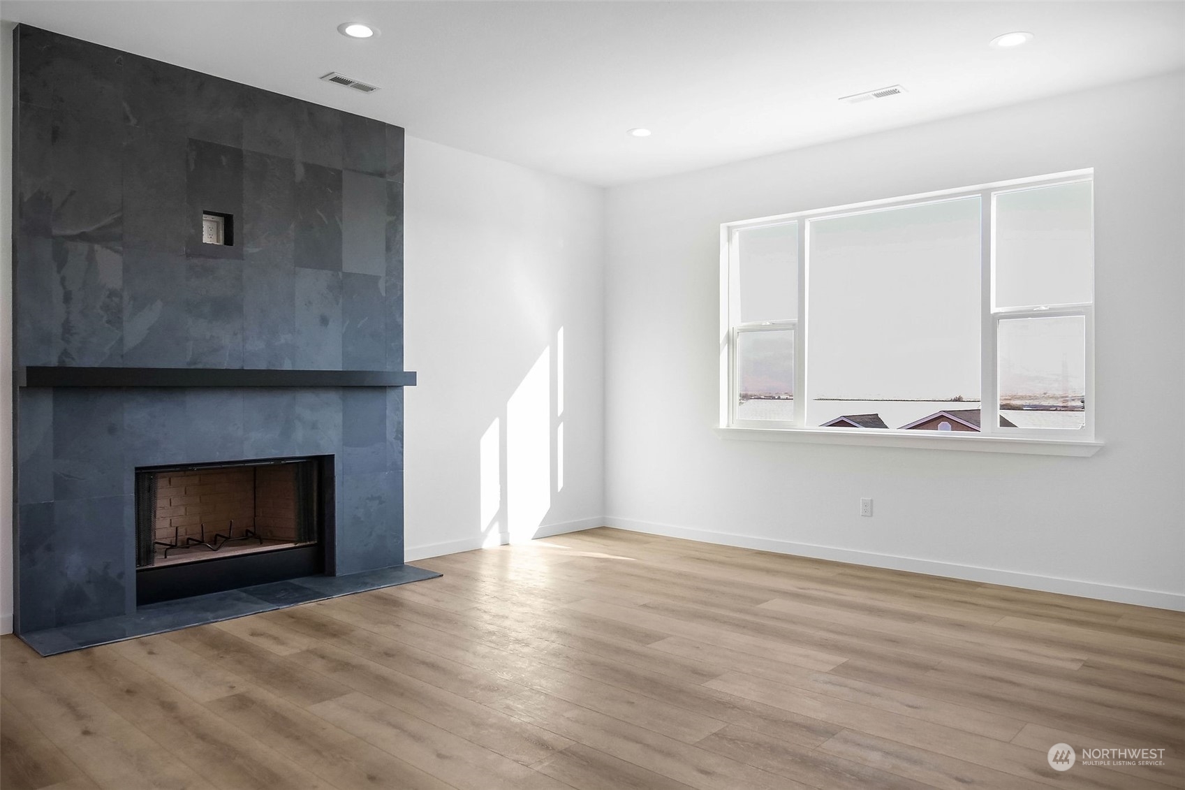431 Strand Road Ephrata, WA 98823 - Photo 32 of 39 a view of an empty room with wooden floor fireplace and a window