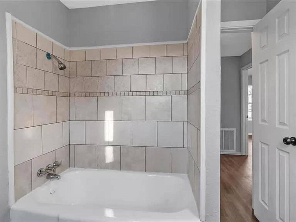 732 East Morton Street Denison, TX 75021 - Photo 13 of 14 a bathroom with a bathtub and a shower