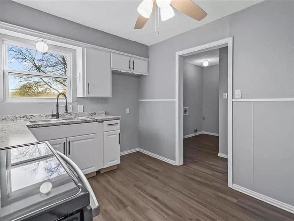 732 East Morton Street Denison, TX 75021 - Photo 3 of 14 a kitchen with a refrigerator and a sink