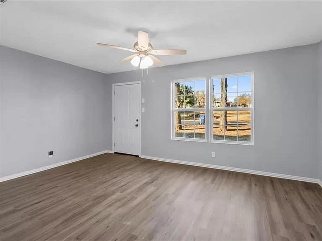 732 East Morton Street Denison, TX 75021 - Photo 5 of 14 a view of an empty room with wooden floor and a window