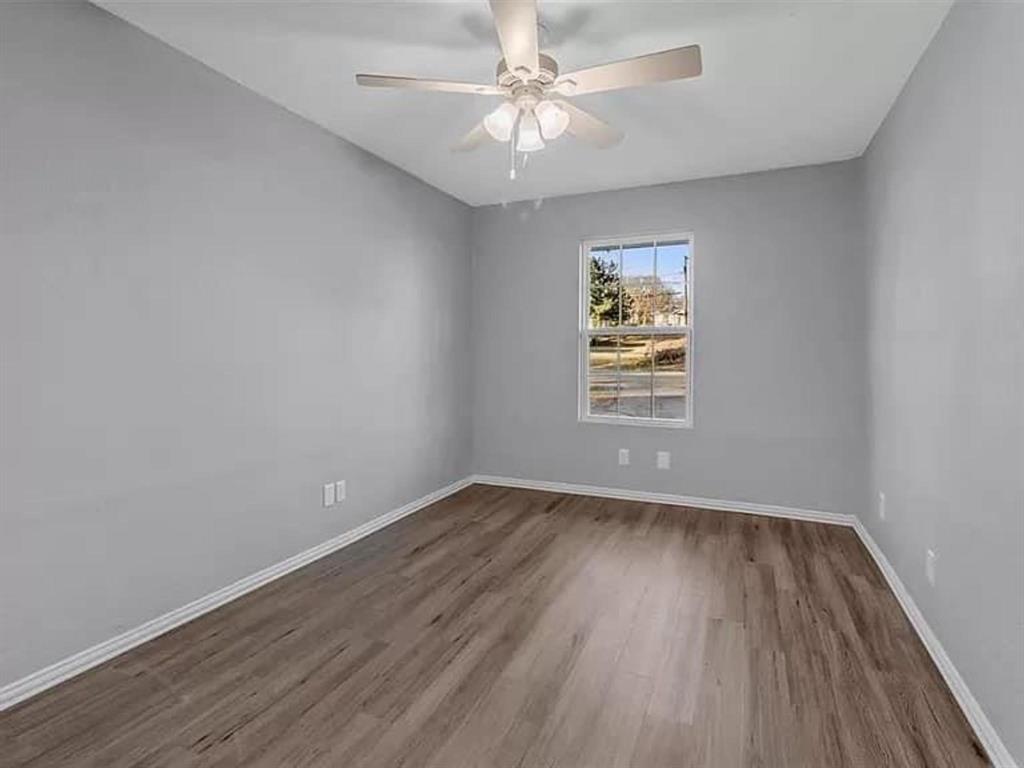732 East Morton Street Denison, TX 75021 - Photo 7 of 14 wooden floor in an empty room with a window