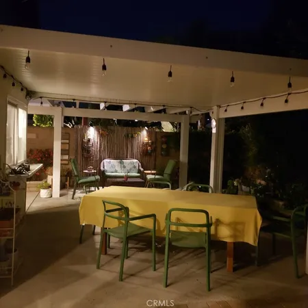 a view of a patio with table and chairs a barbeque grill and plants