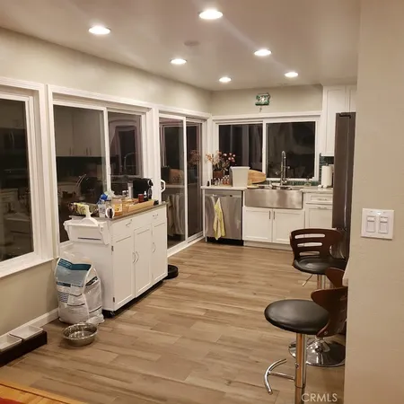 a kitchen with stainless steel appliances kitchen island granite countertop a sink and cabinets