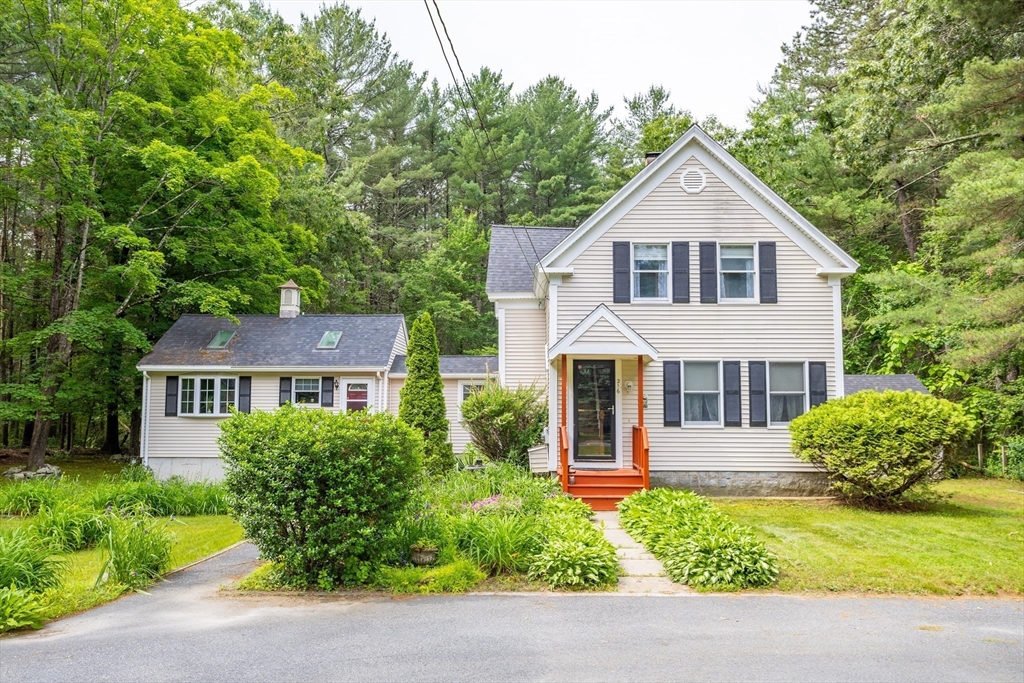 216 Dunstable Road North Chelmsford, MA 01863 - Photo 1 of 42 a front view of a house with garden