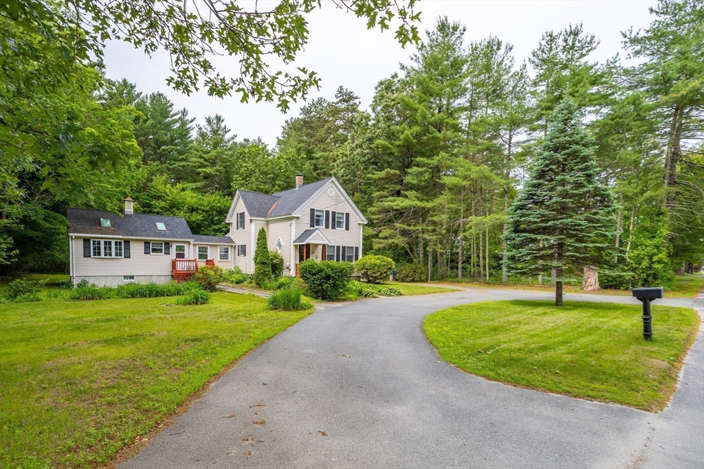 216 Dunstable Road North Chelmsford, MA 01863 - Photo 2 of 42 a front view of a house with a yard