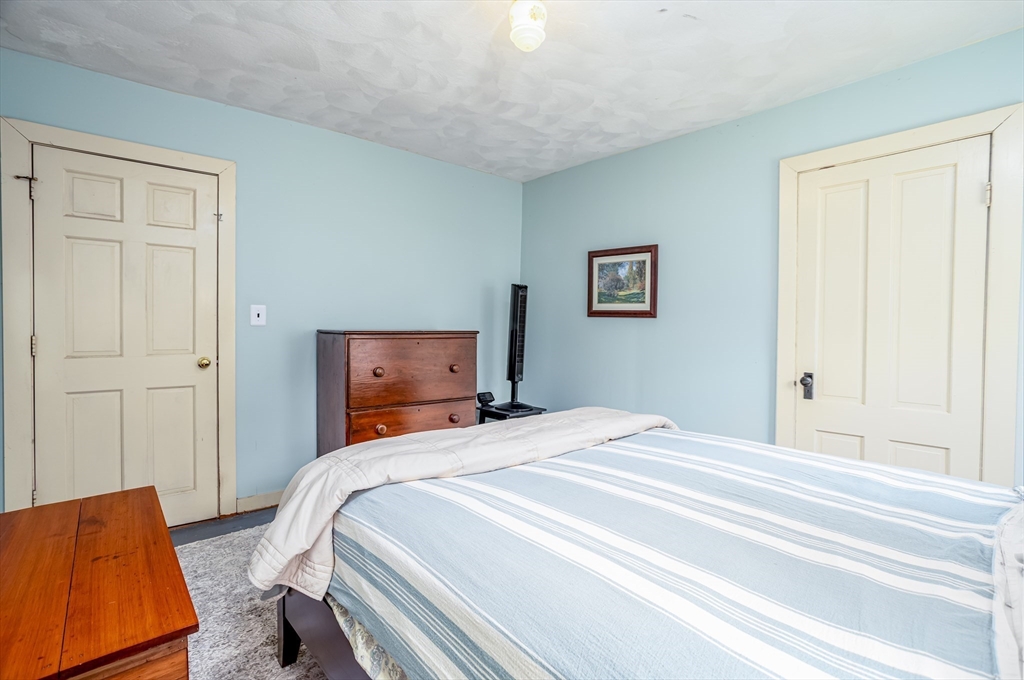 216 Dunstable Road North Chelmsford, MA 01863 - Photo 22 of 42 a bedroom with a bed and a couch