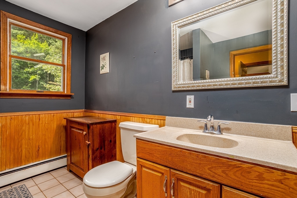 216 Dunstable Road North Chelmsford, MA 01863 - Photo 23 of 42 a bathroom with a sink a toilet and a window