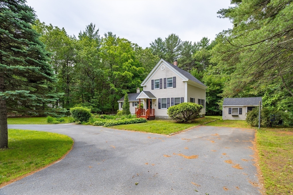 216 Dunstable Road North Chelmsford, MA 01863 - Photo 5 of 42 a front view of a house with a yard
