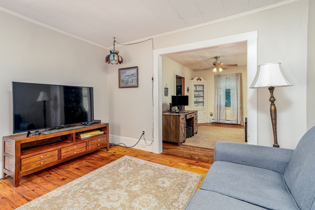 216 Dunstable Road North Chelmsford, MA 01863 - Photo 9 of 42 a living room with furniture and a flat screen tv