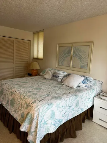 a bedroom with a bed and dresser