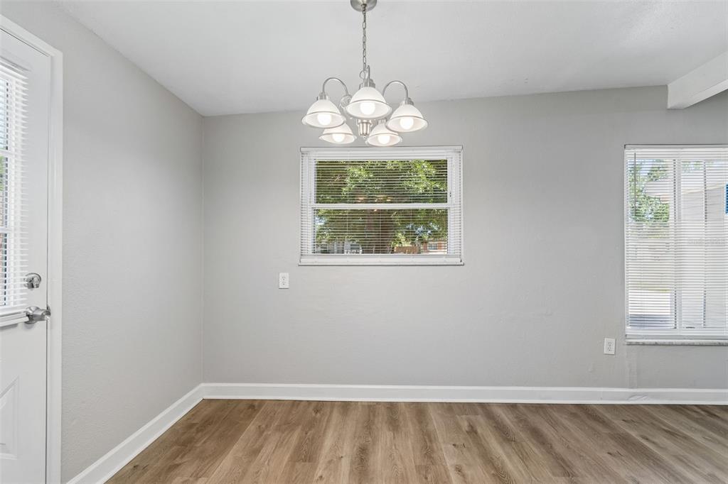 9228 82nd Way Seminole, FL 33777 - Photo 11 of 35 an empty room with wooden floor and windows