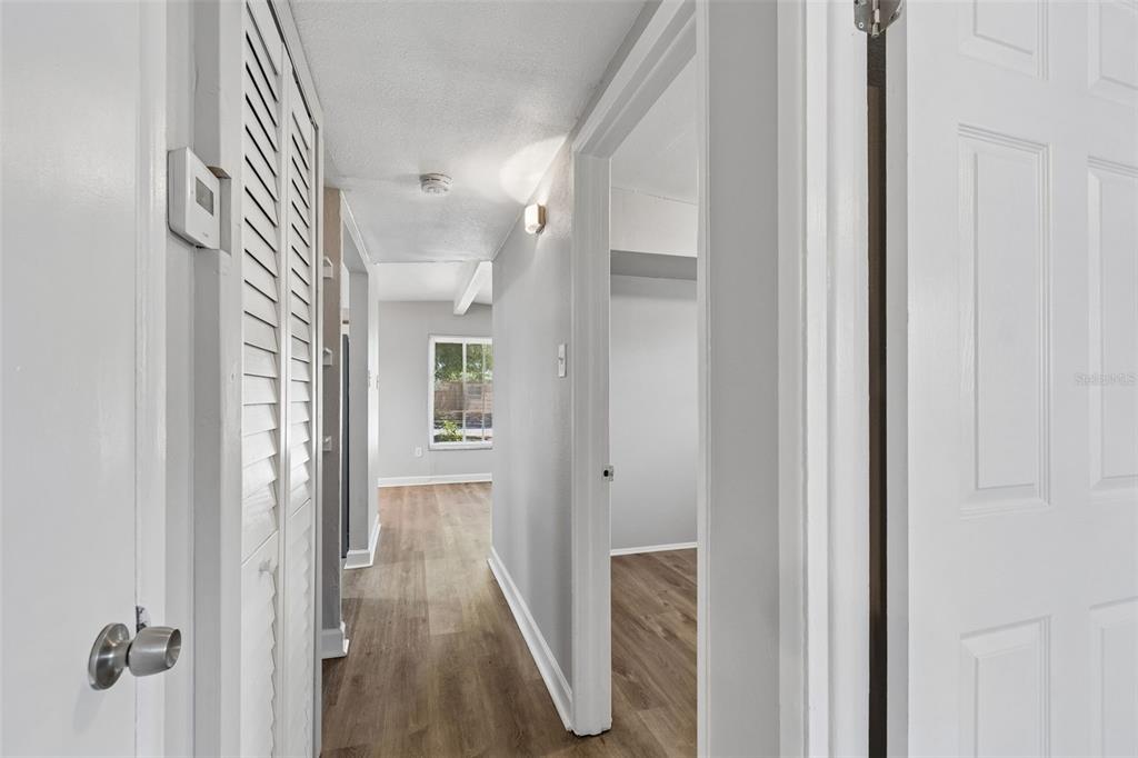 9228 82nd Way Seminole, FL 33777 - Photo 15 of 35 a view of a hallway with wooden floor and closet